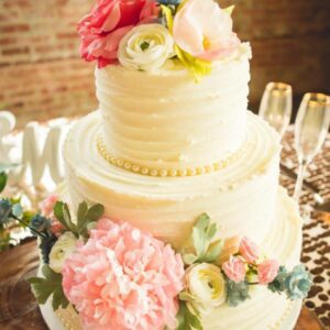 wedding cake with colorful flowers and pearl details.